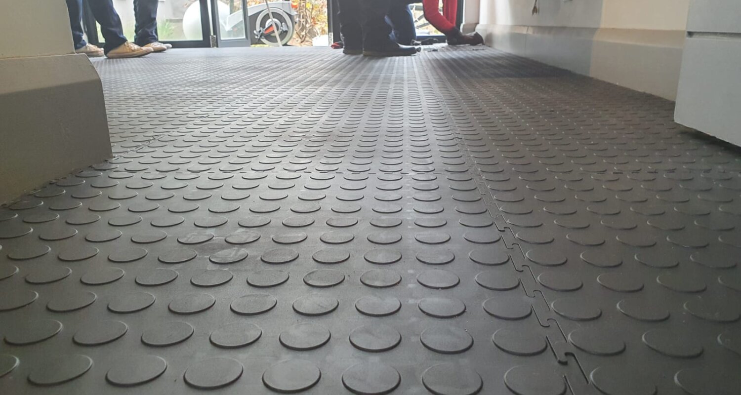 Home 9 Tiepro coin tiles being interlocked during a live installation