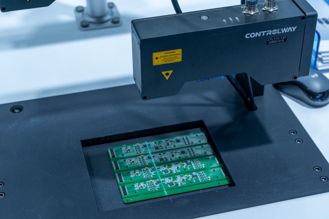 Home 14 Circuit boards under inspection on an electronics production line