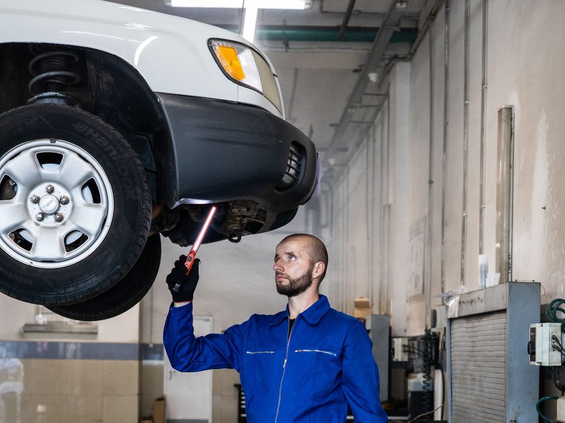 Home 15 Mechanic servicing a vehicle on a workshop lift
